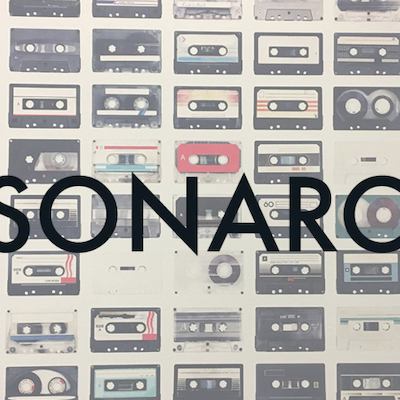 A written logo with tapes in background