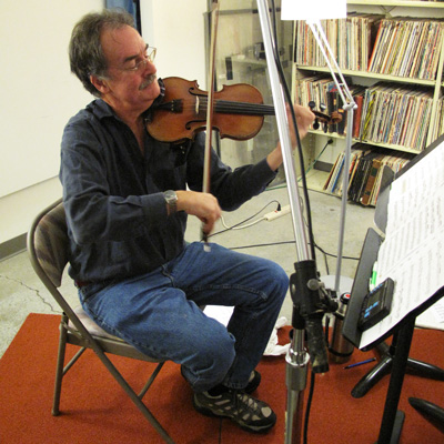 Paul Anastasio plays fiddle in the studio at Jack Straw