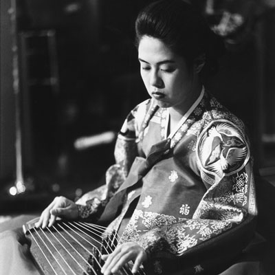 Hye-Jin Chang playing a kayagum (12-stringed zither)