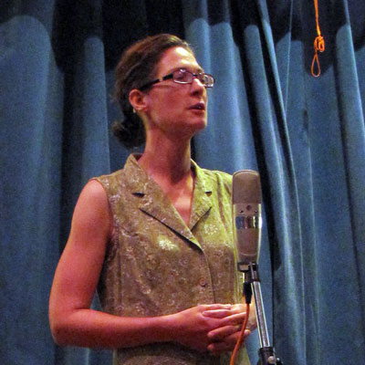 Andrea Braumgarten standing in front of a microphone