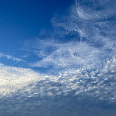 A blue sky with wispy clouds