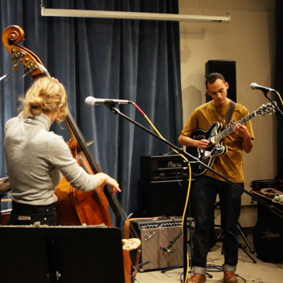Kelsey Mines plays upright bass and Carlos Snaider plays electric guitar in the Jack Straw studio.