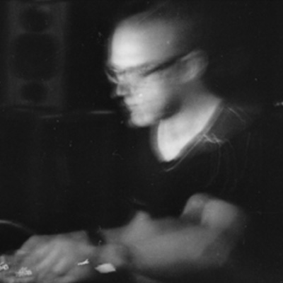 A blurry black and white photo of Jason Kahn.