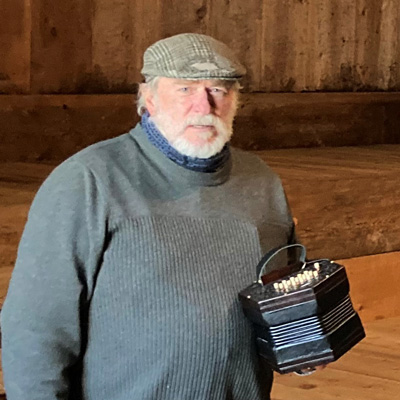 Gregg Dietzman holding a concertina.