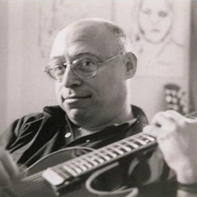 Black and white photo of Ed Petry, holding an electric guitar.