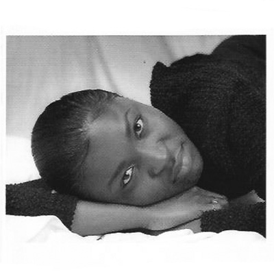 Black and white photo of Folasayo Dele Ogunrinde, resting her head sideways on her hands.