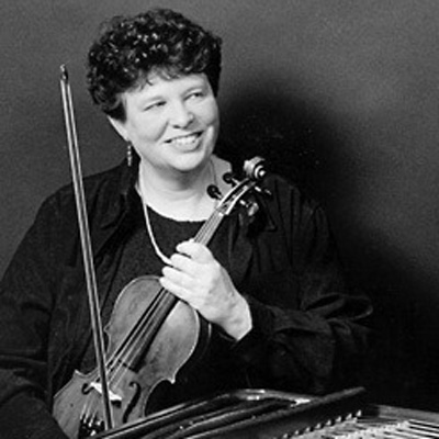 Black and white photo of Sandra Layman, holding a violin