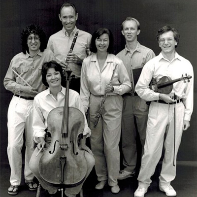 Black and white photo of six people holding musical instruments.