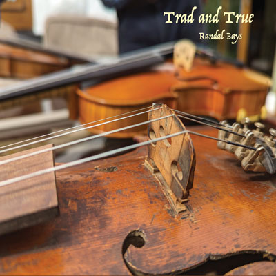 Two violins, one in the foreground in closeup, with text reading Trad and True, Randal Bays.