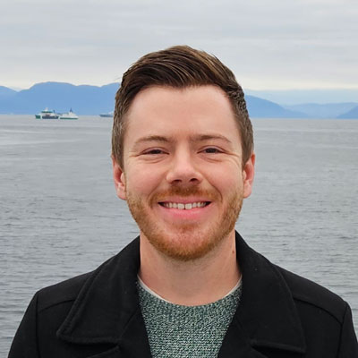 Steven Luksan, with sea and mountains in the background.